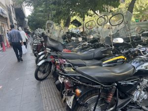 Motorcycles parked by the hundreds on the sidewalks